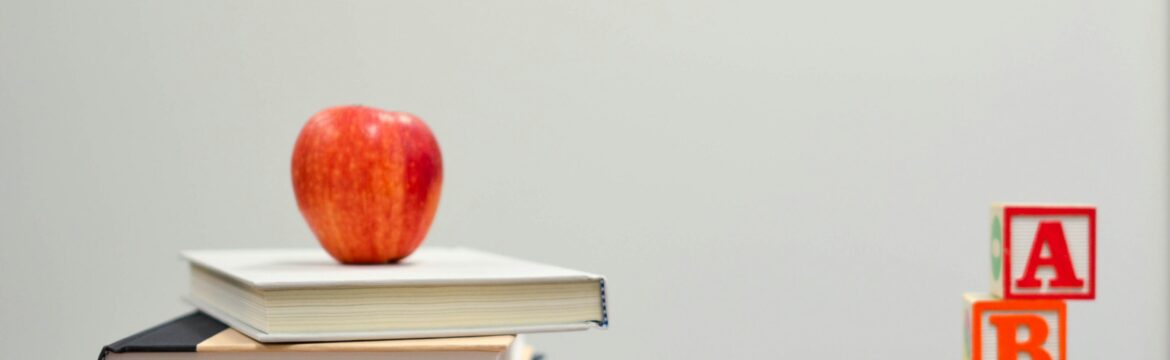 image of an apple, books, pencils and letters to illustrate post about back to school safety